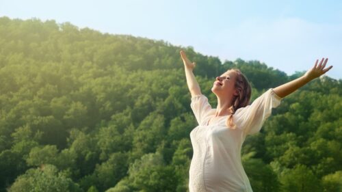 澄み渡った自然の香りを楽しむ女性